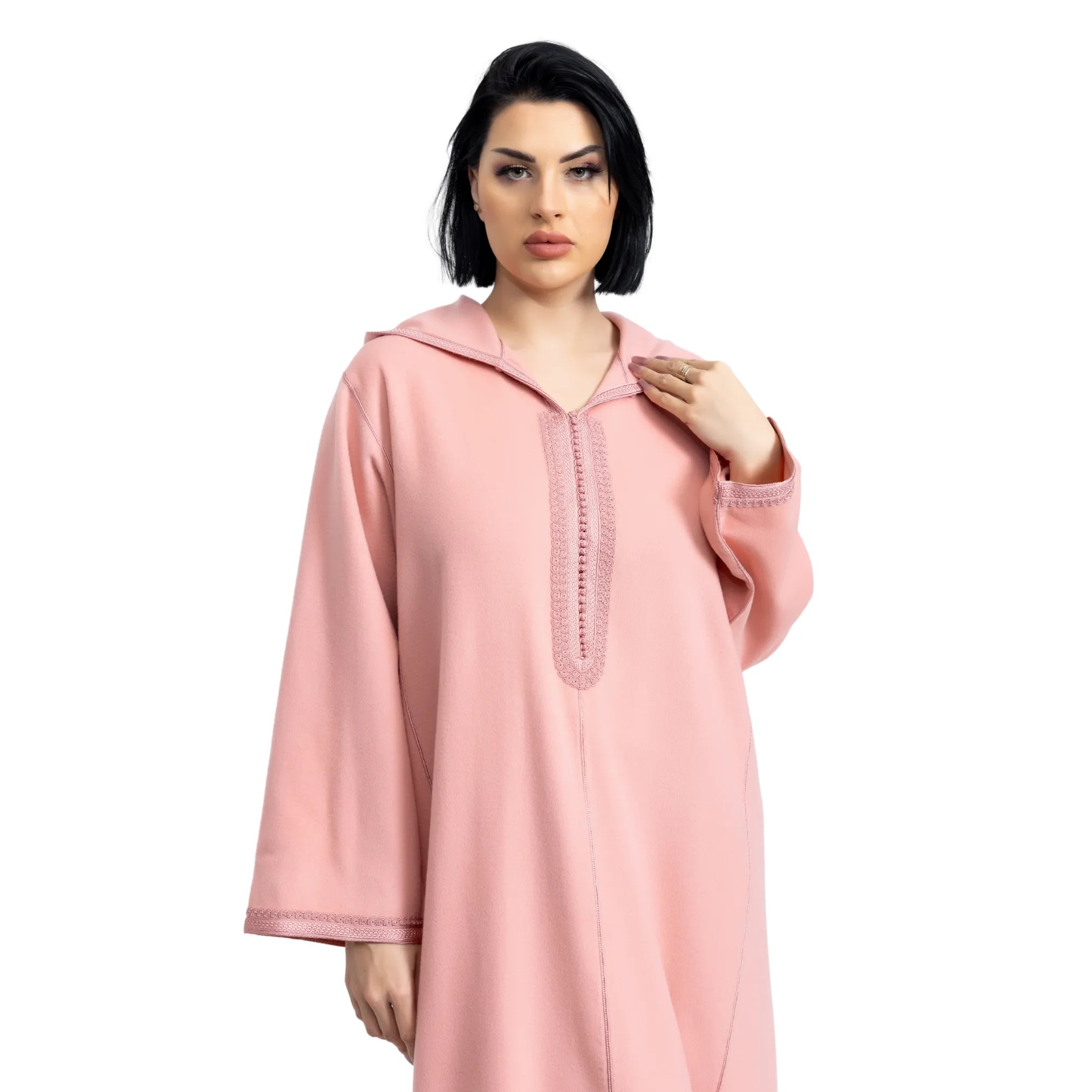 Woman wearing a pink jalabiya on a white background
