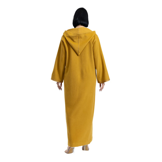 Person wearing a mustard yellow hooded jalabiya on a white background