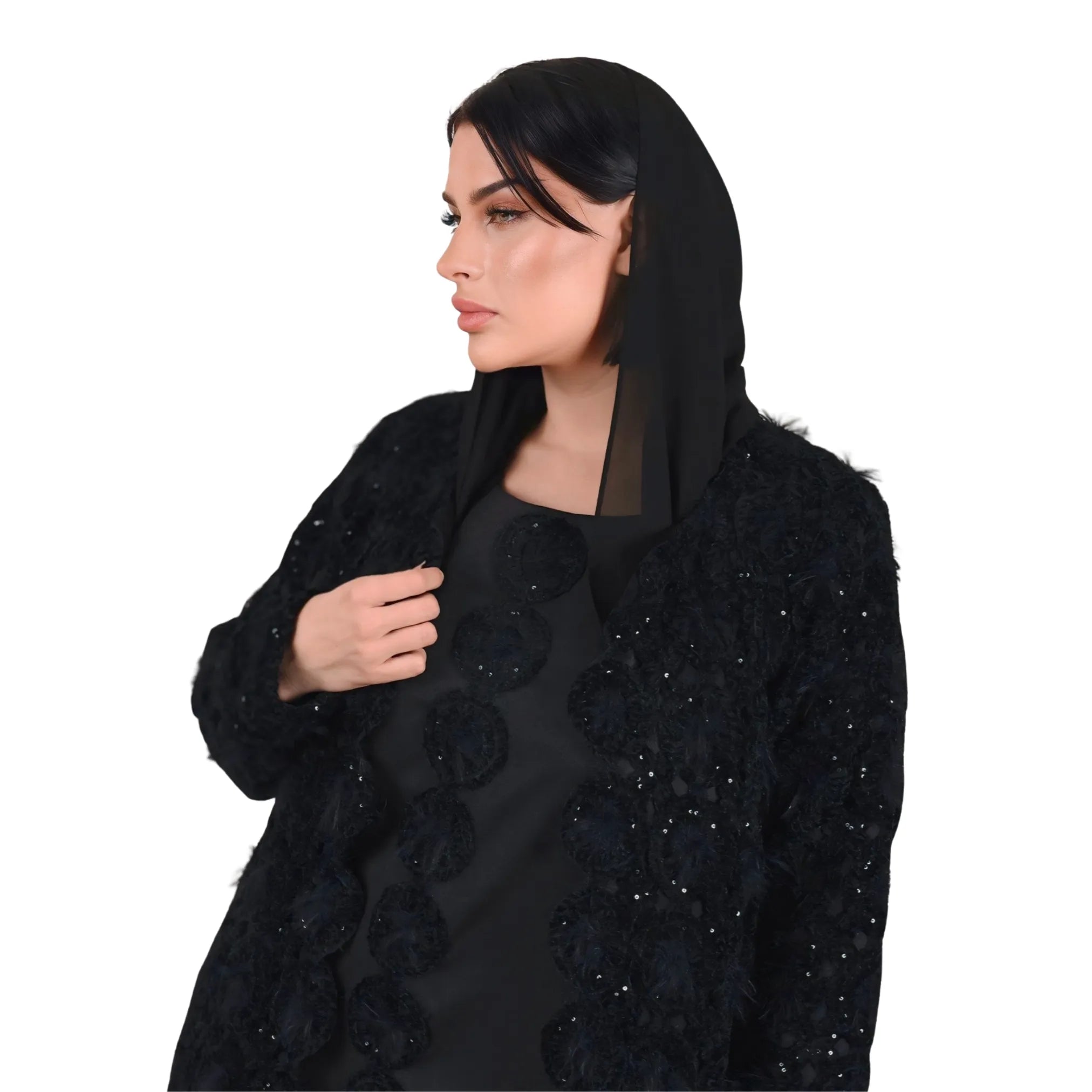 Woman wearing a black embroidered abaya on a white background