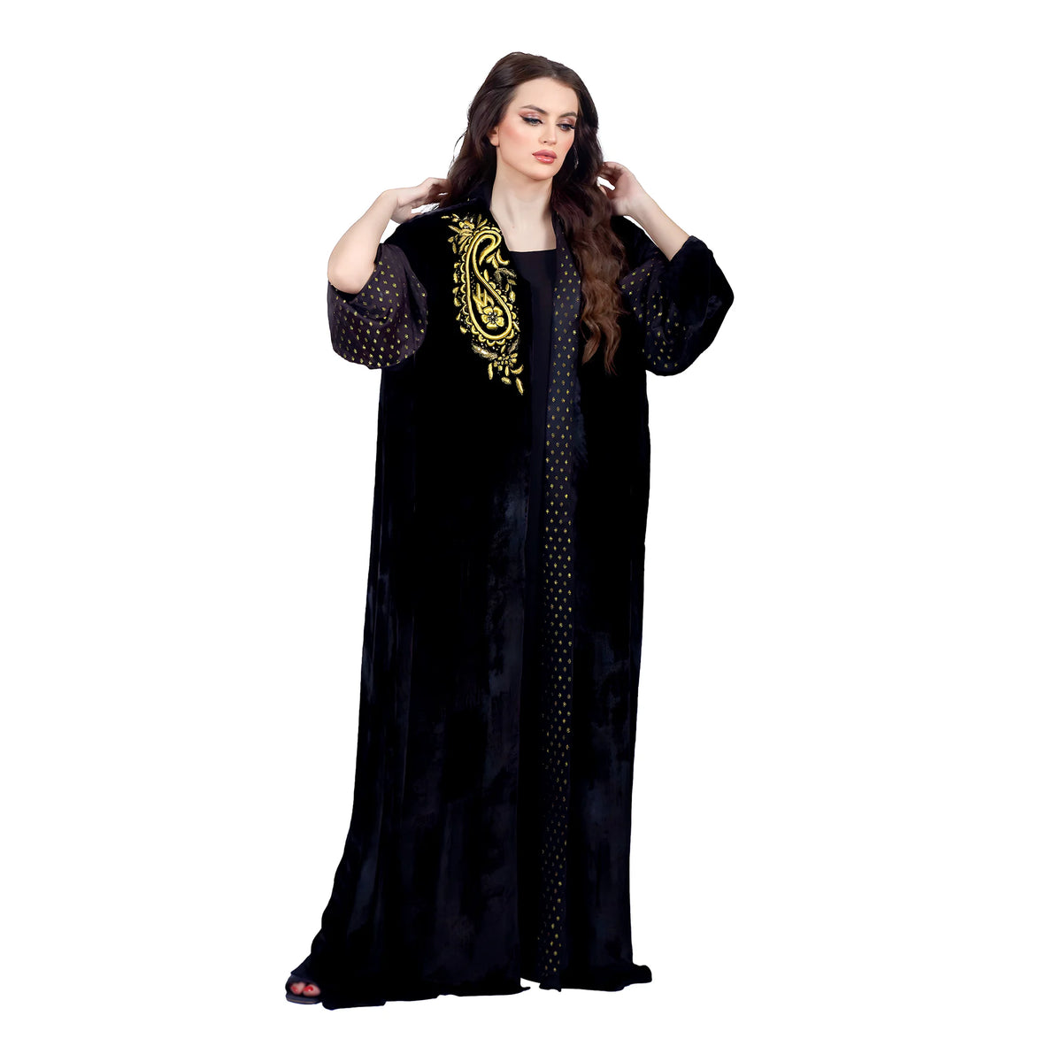 Woman wearing a black abaya with gold embroidery on a white background