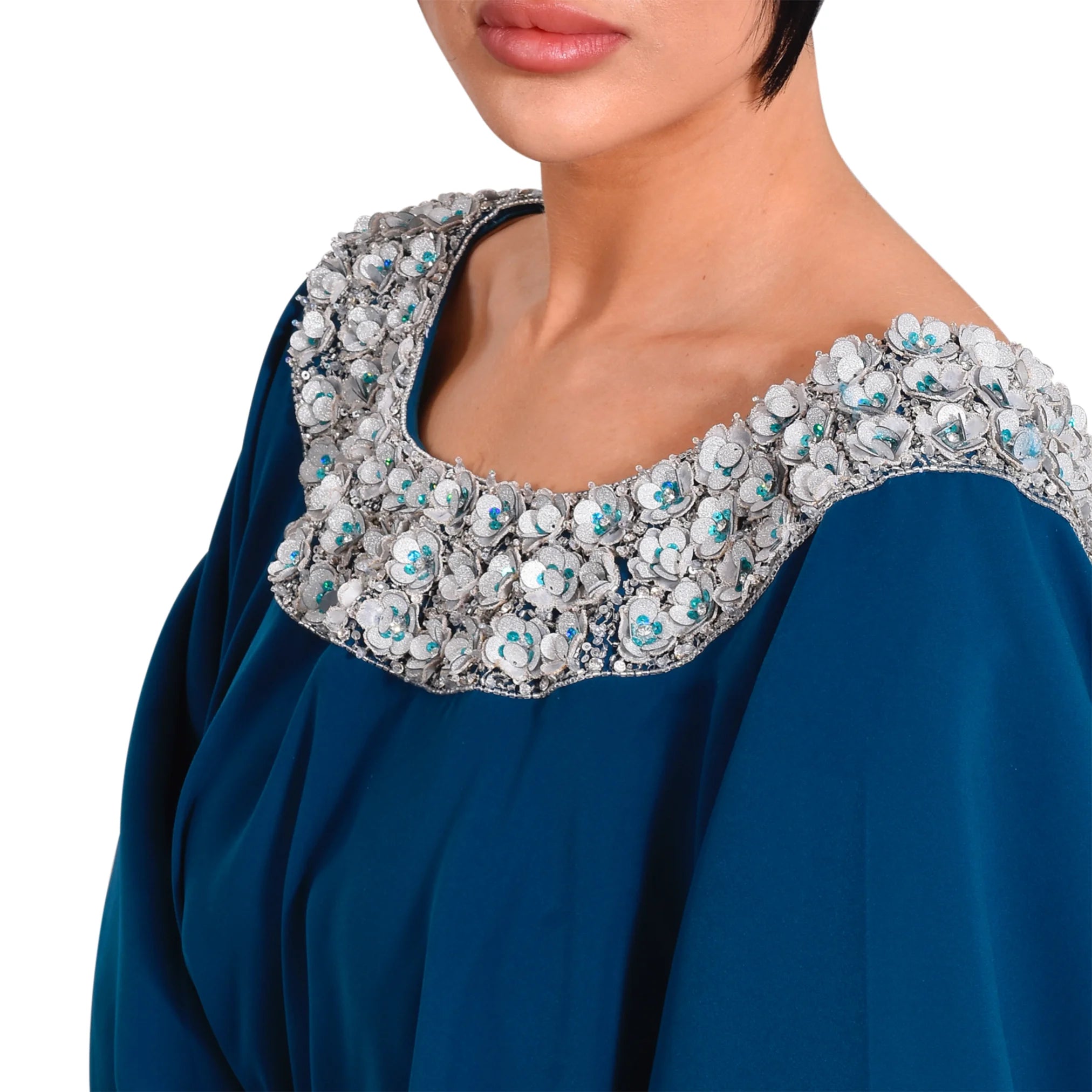 Blue garment with a detailed, embellished neckline on a white background