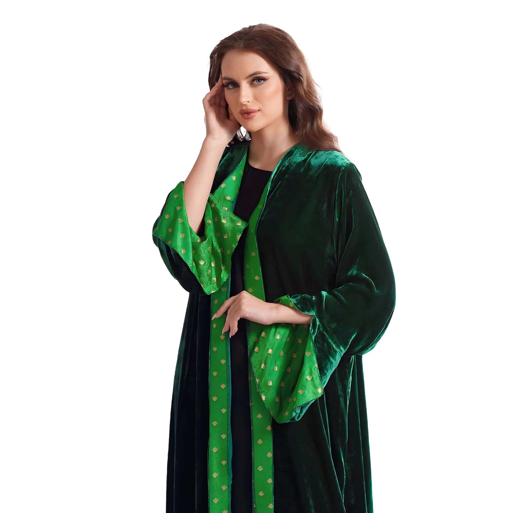 Woman wearing a green velvet abaya with gold patterns on a white background