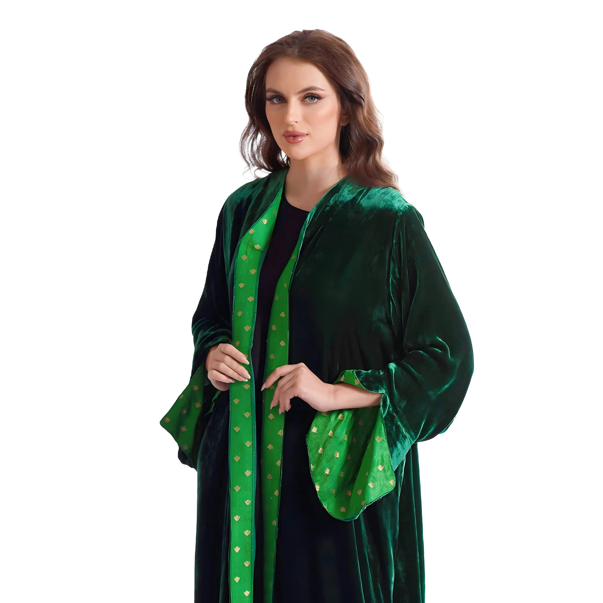 Woman wearing a green velvet abaya with gold accents on a white background