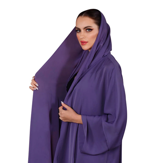Woman wearing a purple abaya on a white background