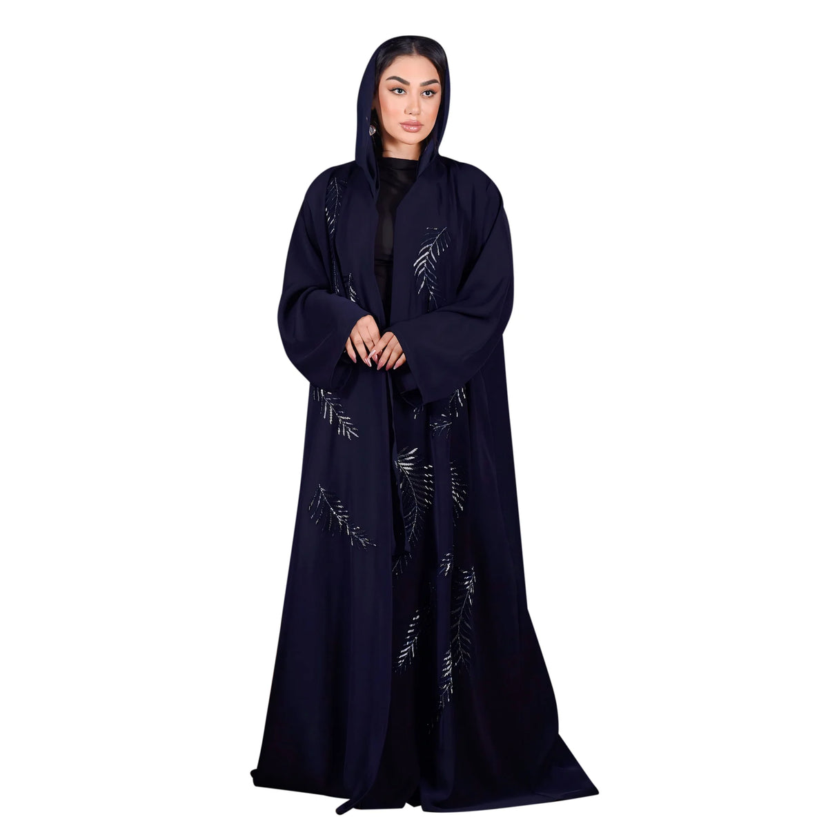 Woman wearing a dark blue abaya with embroidery on a white background