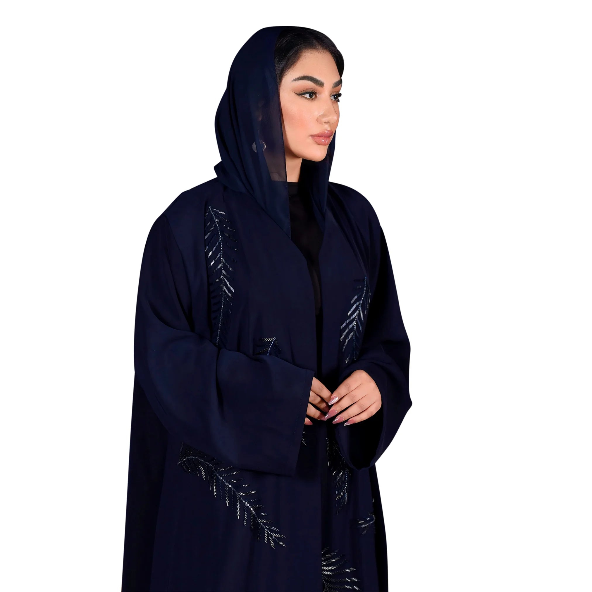 Woman wearing a dark blue abaya with embroidery on a white background