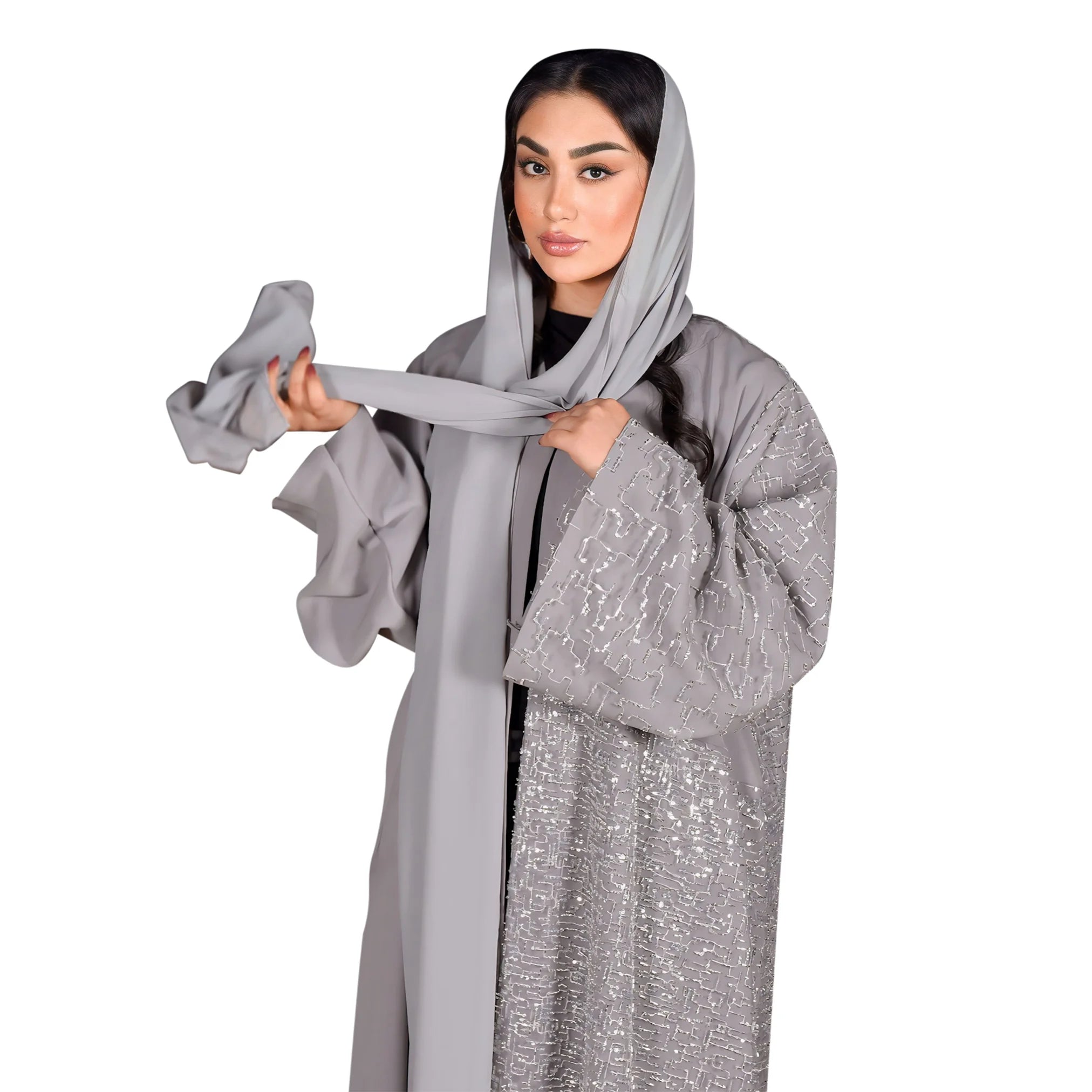 Woman wearing a gray abaya with a matching headscarf on a white background