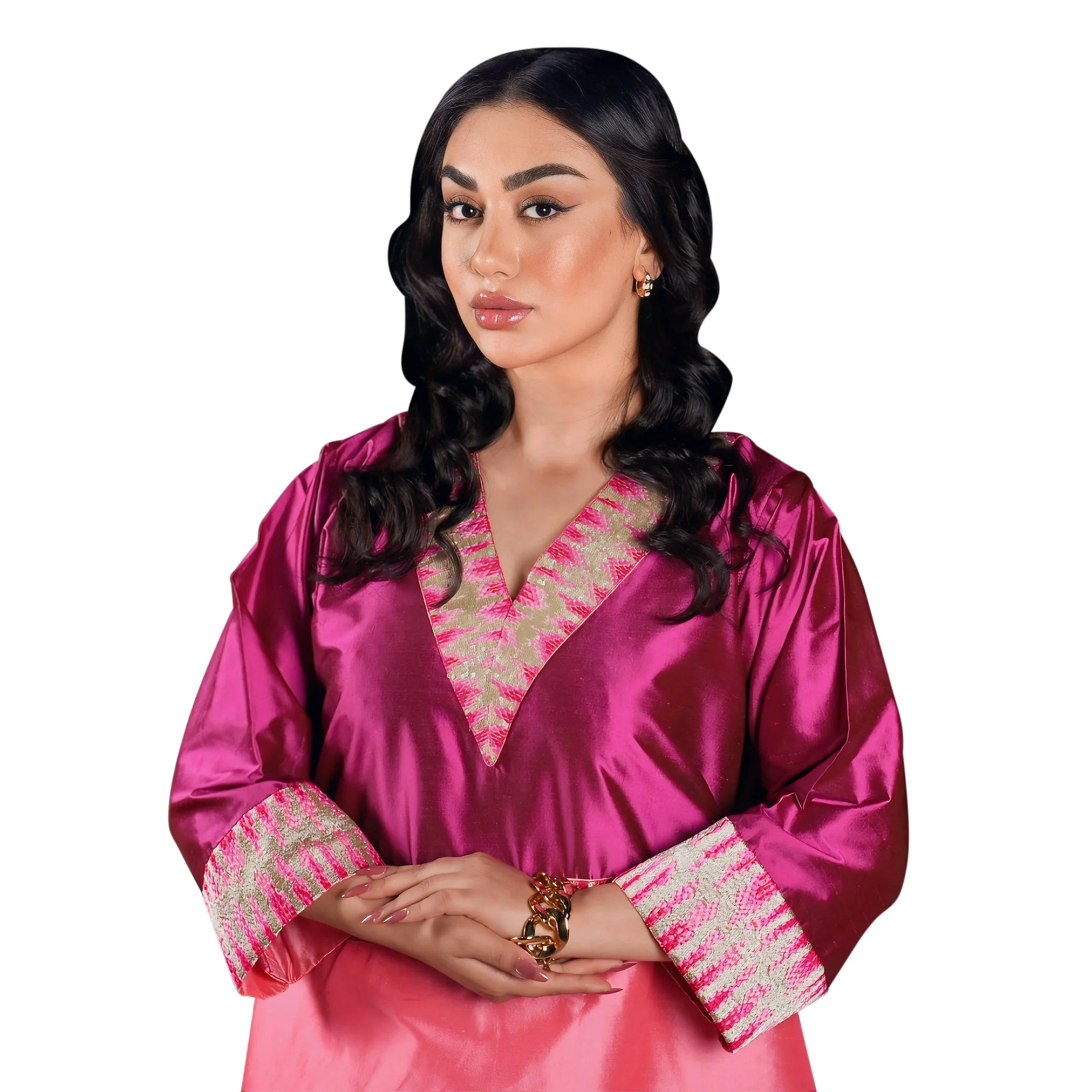 Woman wearing a pink traditional outfit with intricate designs on a white background